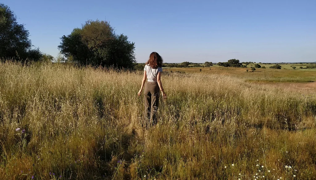 A woman standing in a field of tall grass