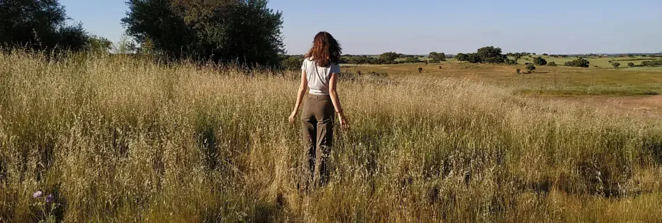 A woman standing in a field of tall grass