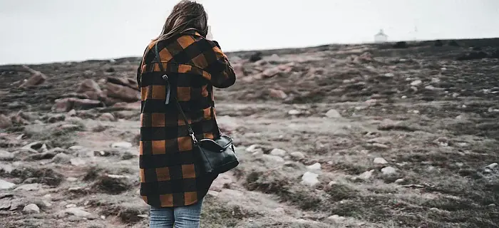 Back View of a Woman Wearing a Plaid Shirt and Denim Pants