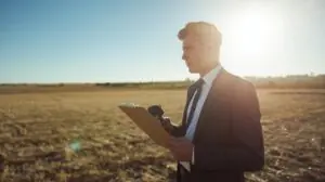 Professional appraiser evaluating inherited land’s fair market value.